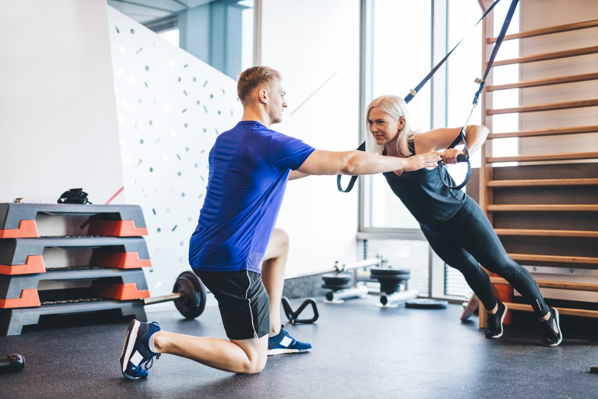 woman-exercising-with-personal-trainer-at-the-gym--e1677564552103.jpg